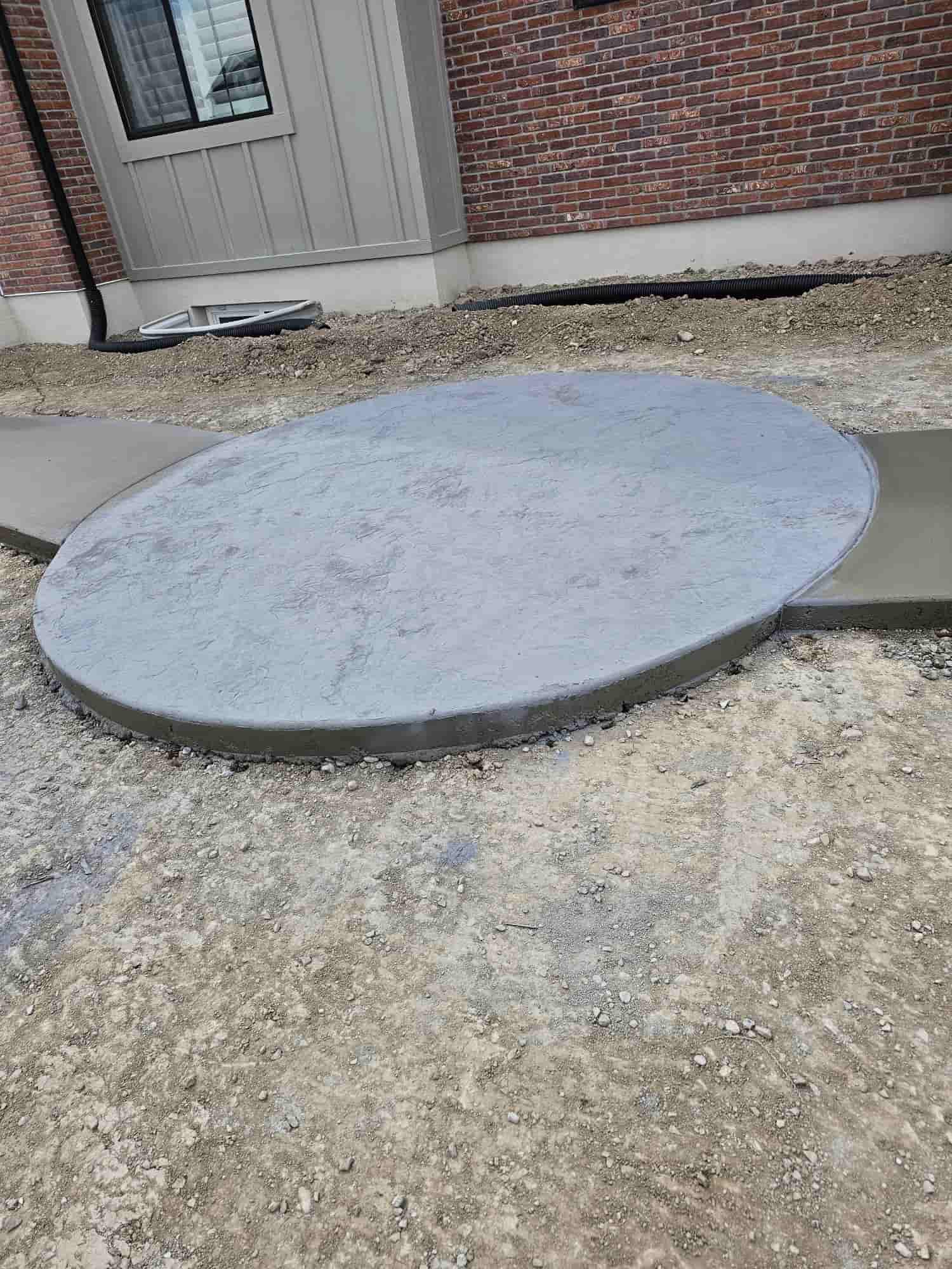 Broom, trowel or exposed finish, pitched away from the foundation so meltwater leaves instead of pooling.