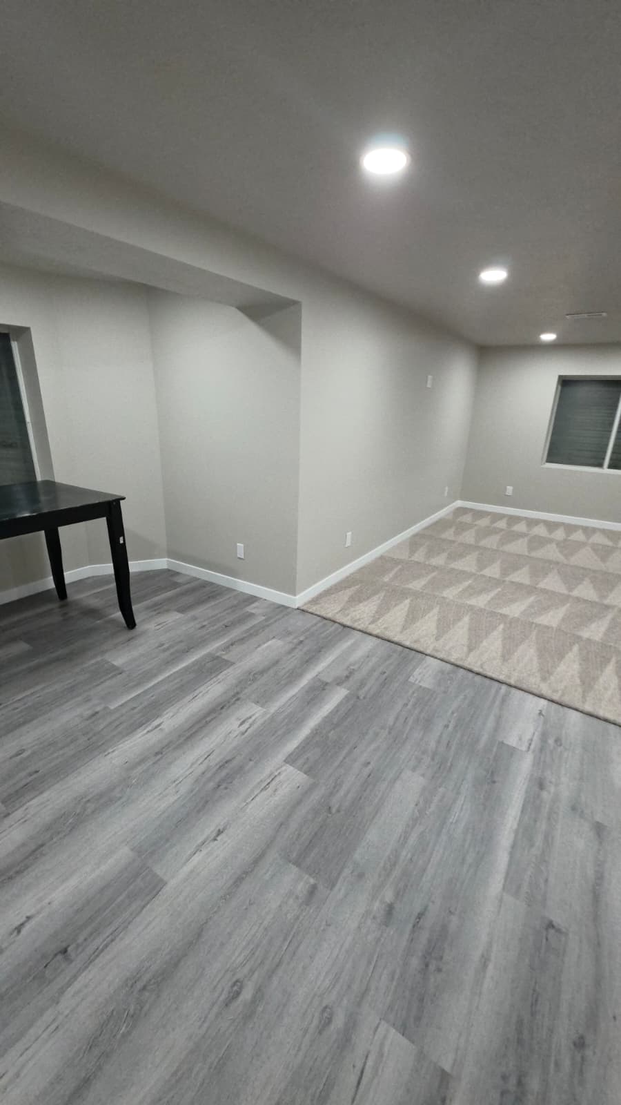 Permitted basement finishes with code-sized egress windows, framing built for a concrete floor, and inspections scheduled in order.
