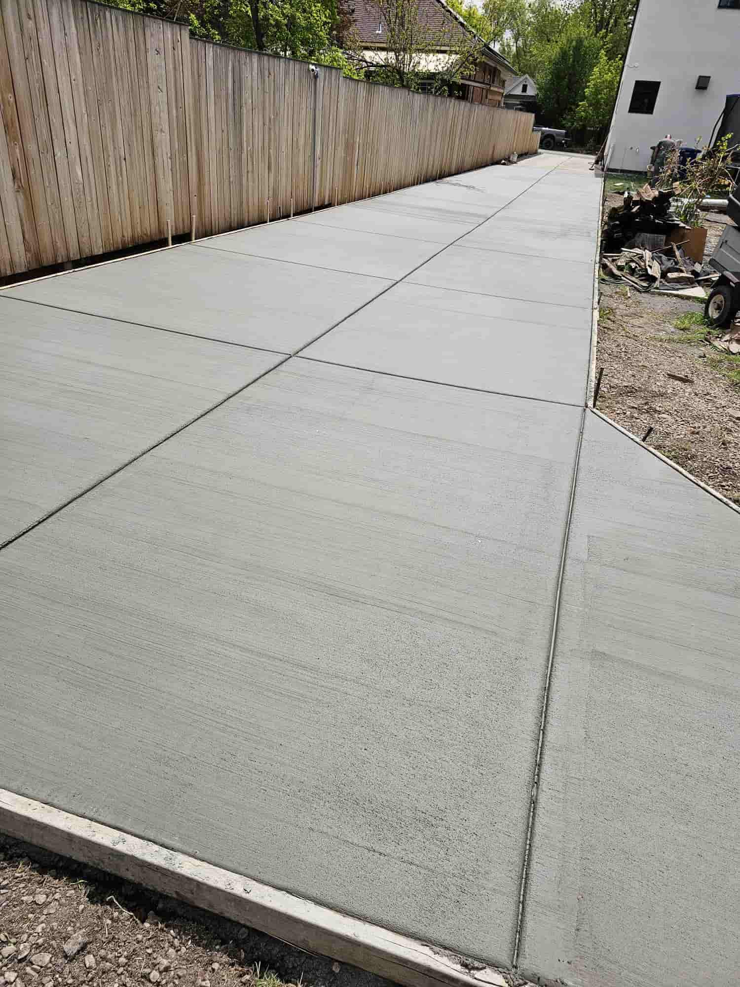 Finished concrete slab running the length of a timber fence line