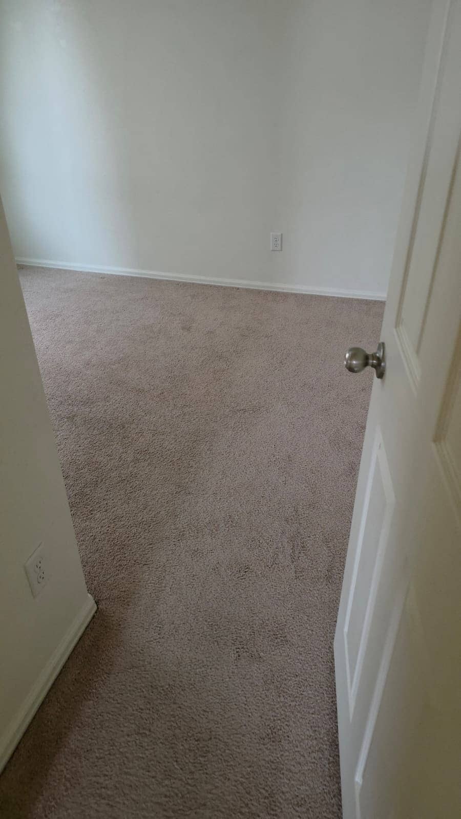 Finished carpeted room seen through a doorway